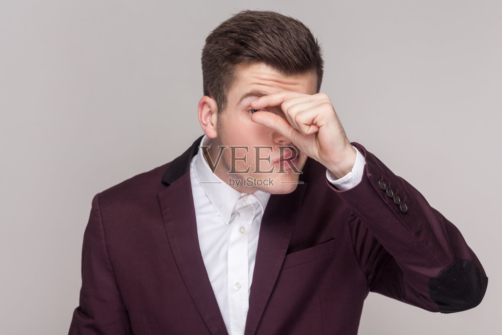 有魅力的英俊青年把手指放在眼睛附近，做些小手势，偷窥。照片摄影图片