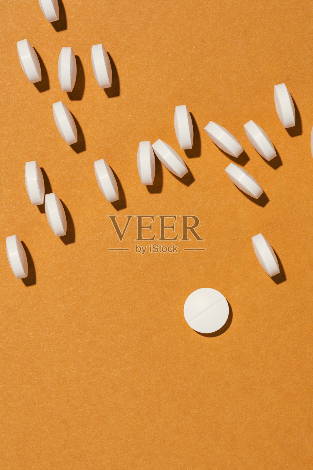 橙色背景上的白色药片照片摄影图片