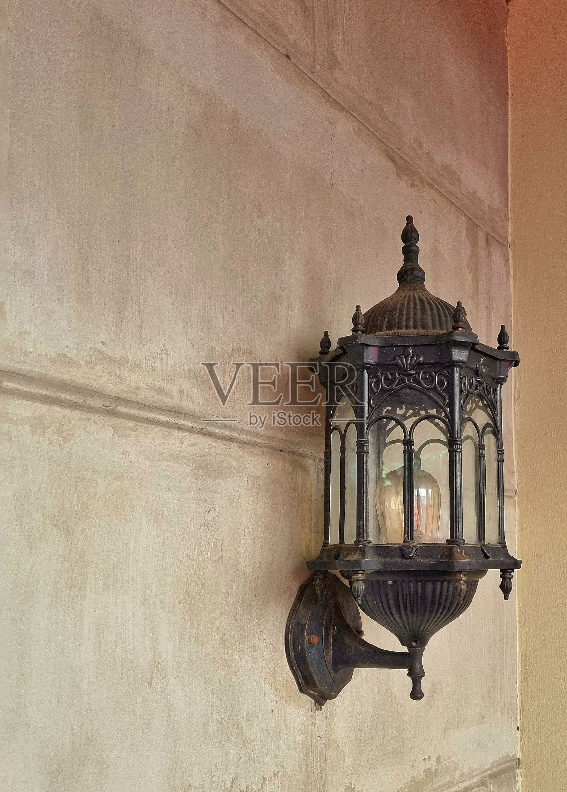 墙上挂着一盏古老的黑灯照片摄影图片