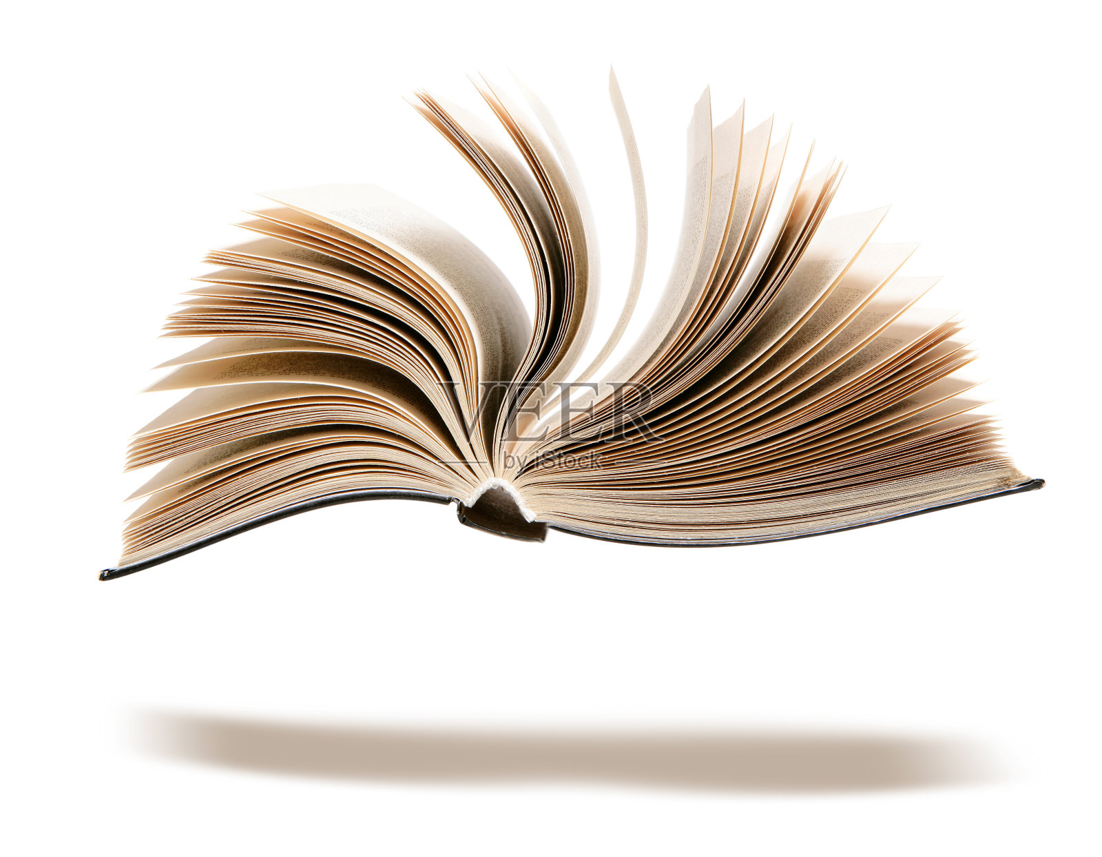 翻开的书有一个影子孤立在白色上。照片摄影图片