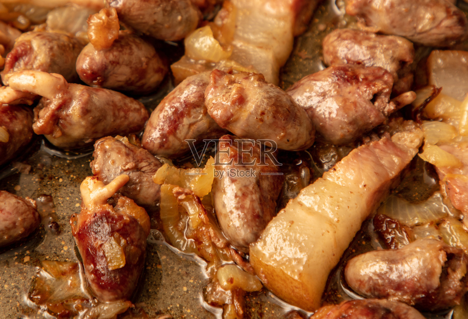 鸡心在油锅里煎照片摄影图片