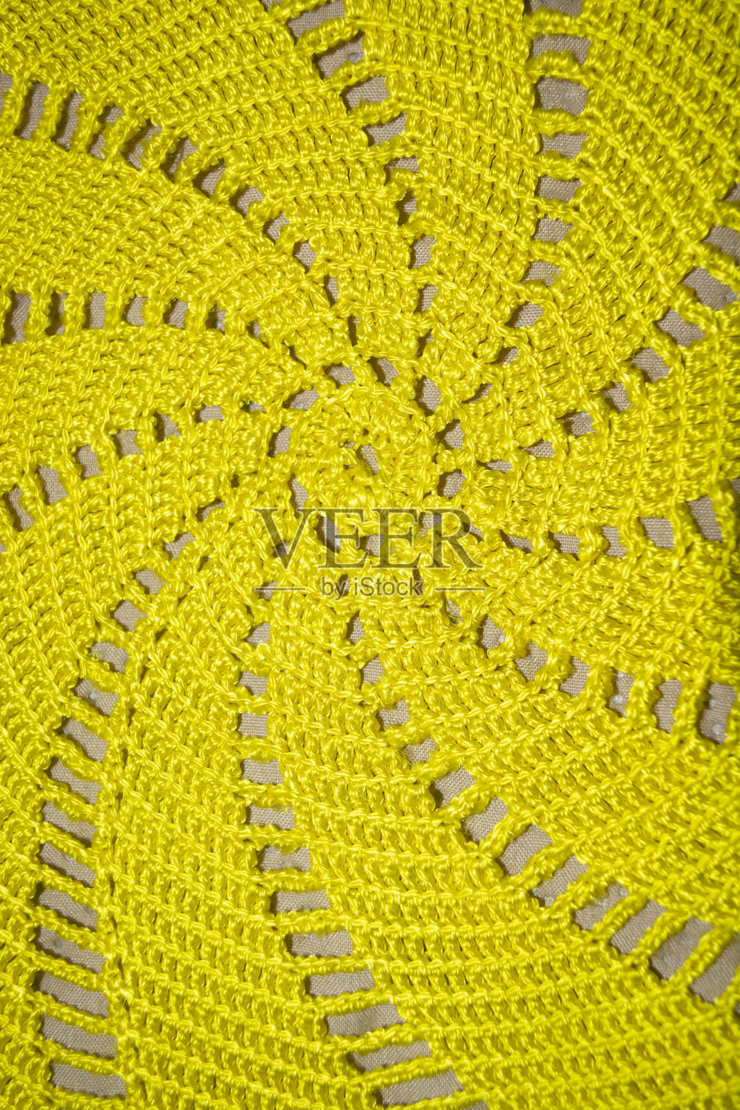 黄色钩针织物。钩针织物的质地照片摄影图片
