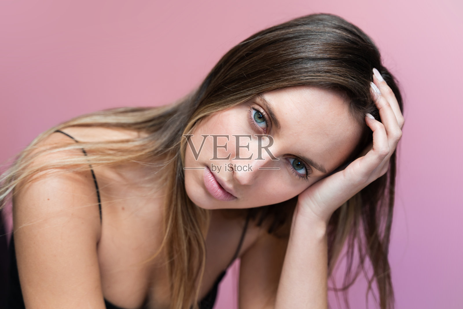 粉色背景上的女人特写。照片摄影图片