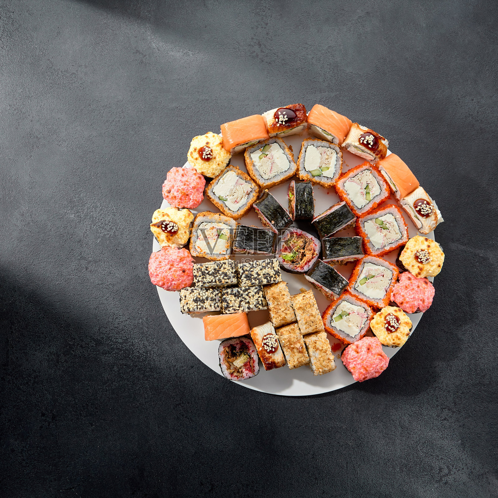 经典及焙烤寿司卷;费城面包卷淋上辣酱，融合了温暖和传统照片摄影图片