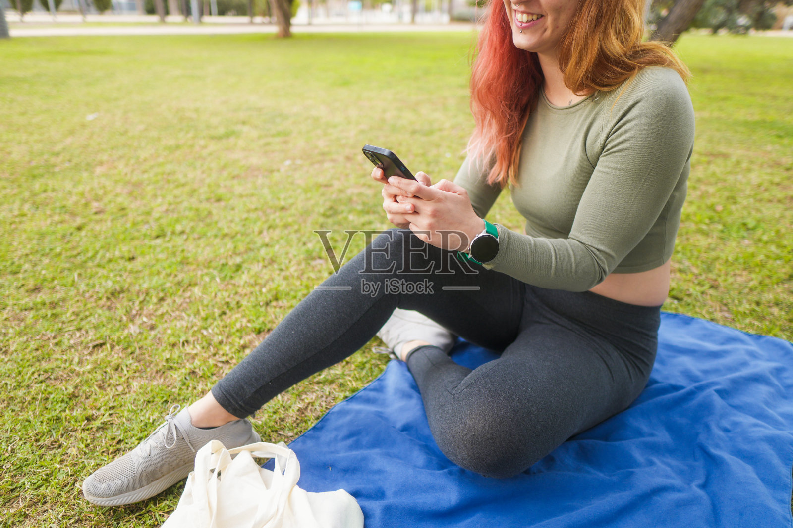 微笑的女人在手机上发短信照片摄影图片