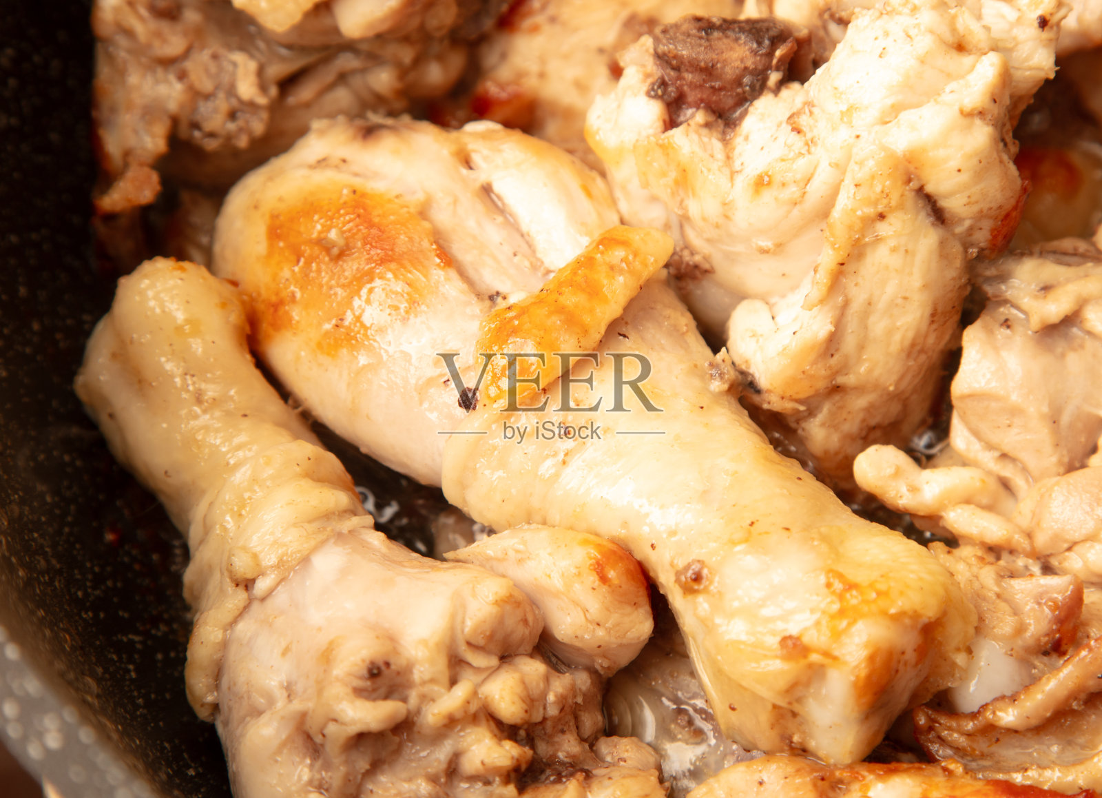 鸡肉在煎锅里炖照片摄影图片