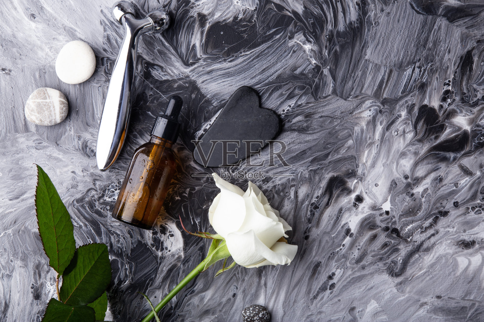 极简的护肤设置与按摩辊，精华液，瓜沙流体艺术背景照片摄影图片