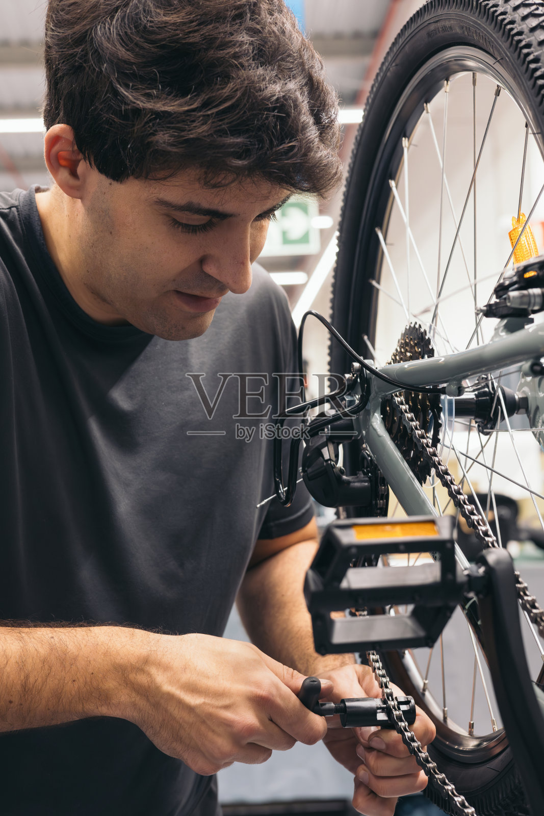 车间立式人像自行车修理工调整链条照片摄影图片