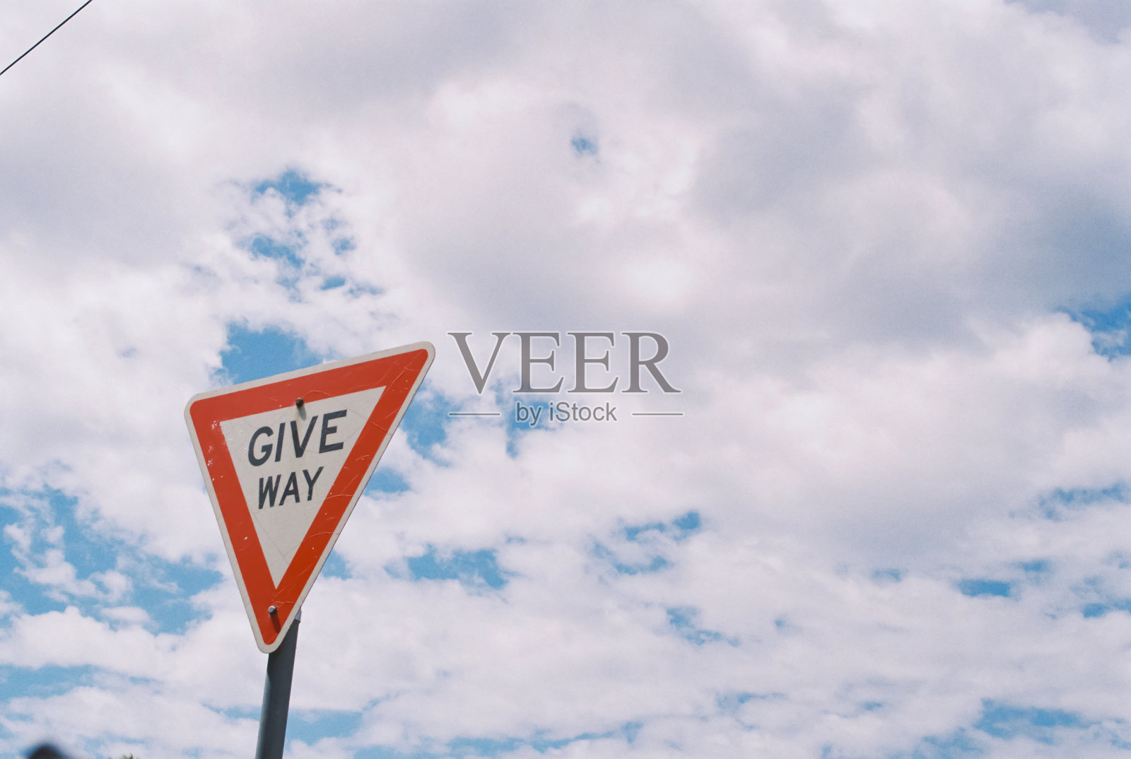 在一些树前有一个写着“让路”的路标照片摄影图片