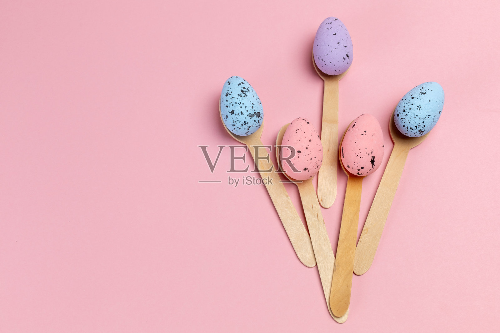 用木勺给复活节彩蛋上色。照片摄影图片