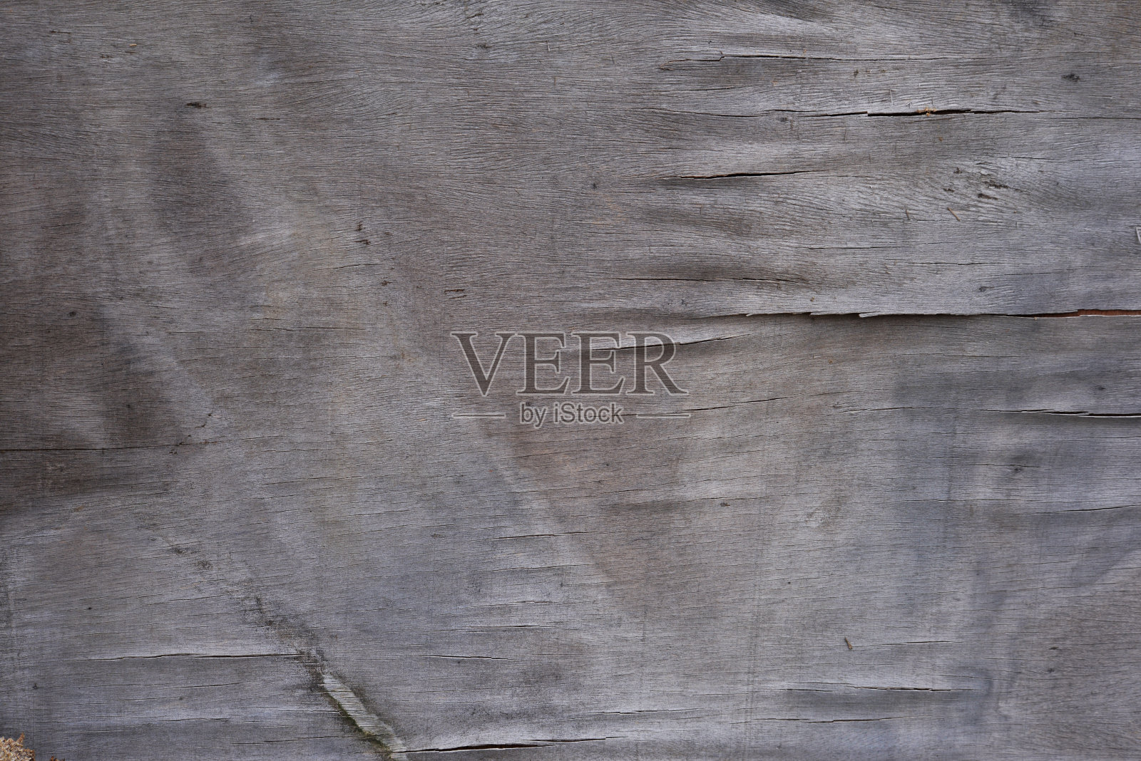 一张破旧的胶合板的特写，上面有裂缝和划痕。照片摄影图片