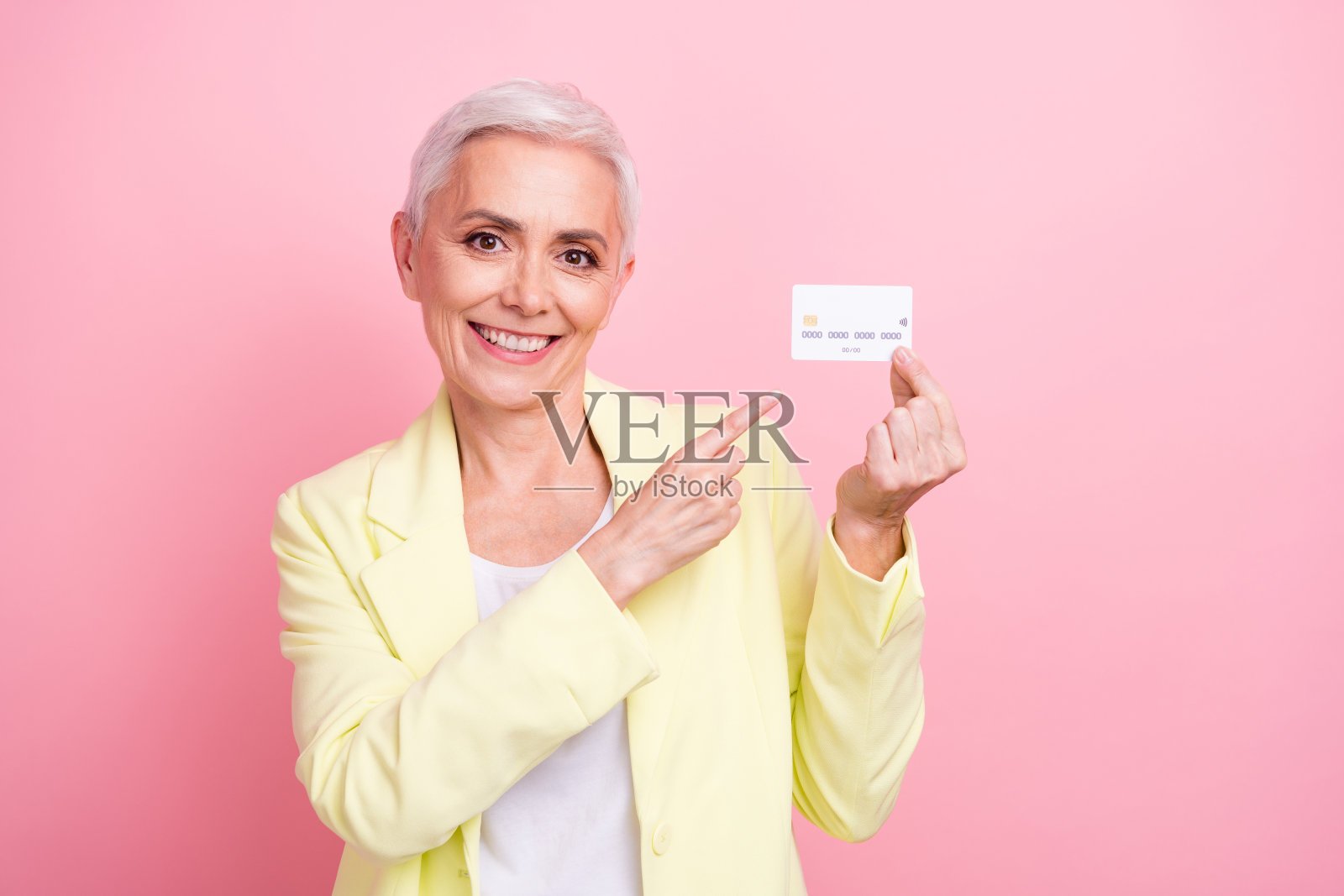 肖像照片的成功愉快的企业主妇女点手指借记卡支付购物孤立在粉红色的背景照片摄影图片