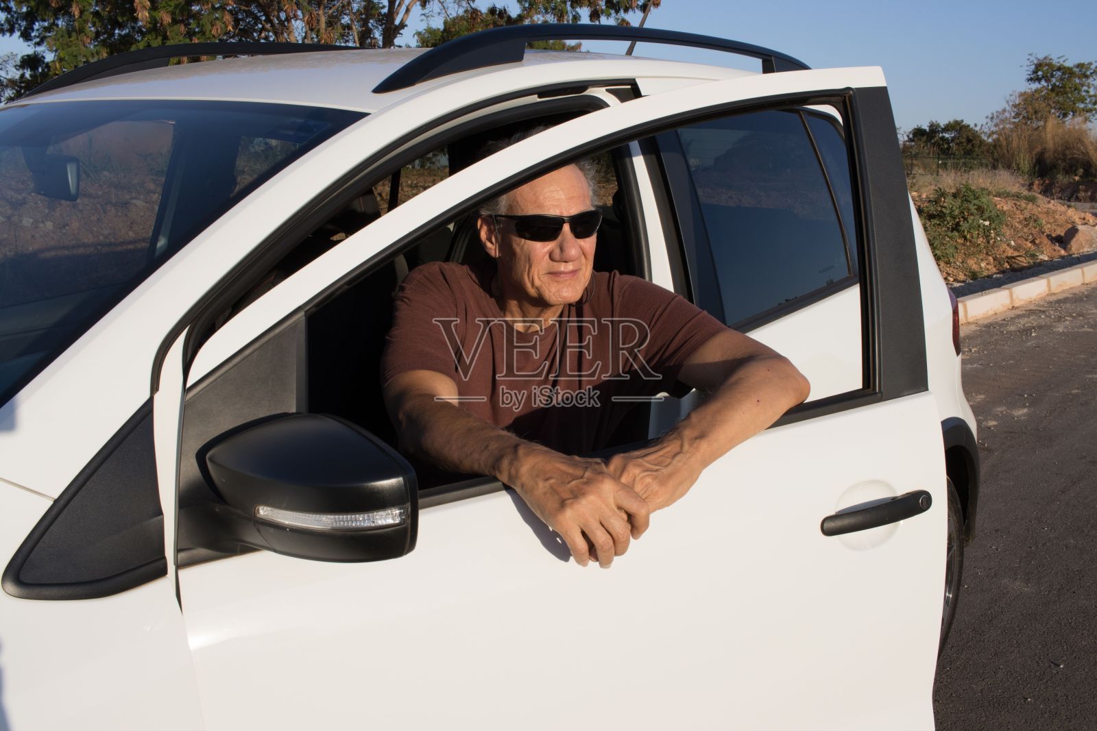 戴墨镜的男人坐在车里照片摄影图片