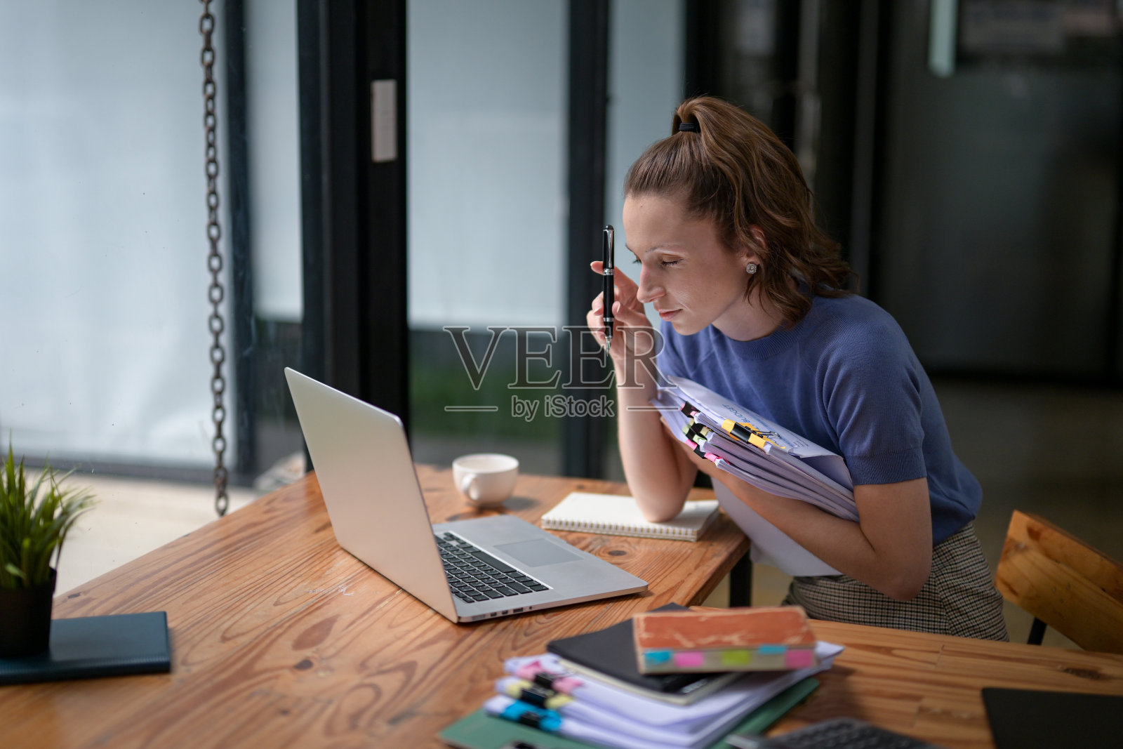 女商人拿着一大堆文件，搜索着照片摄影图片