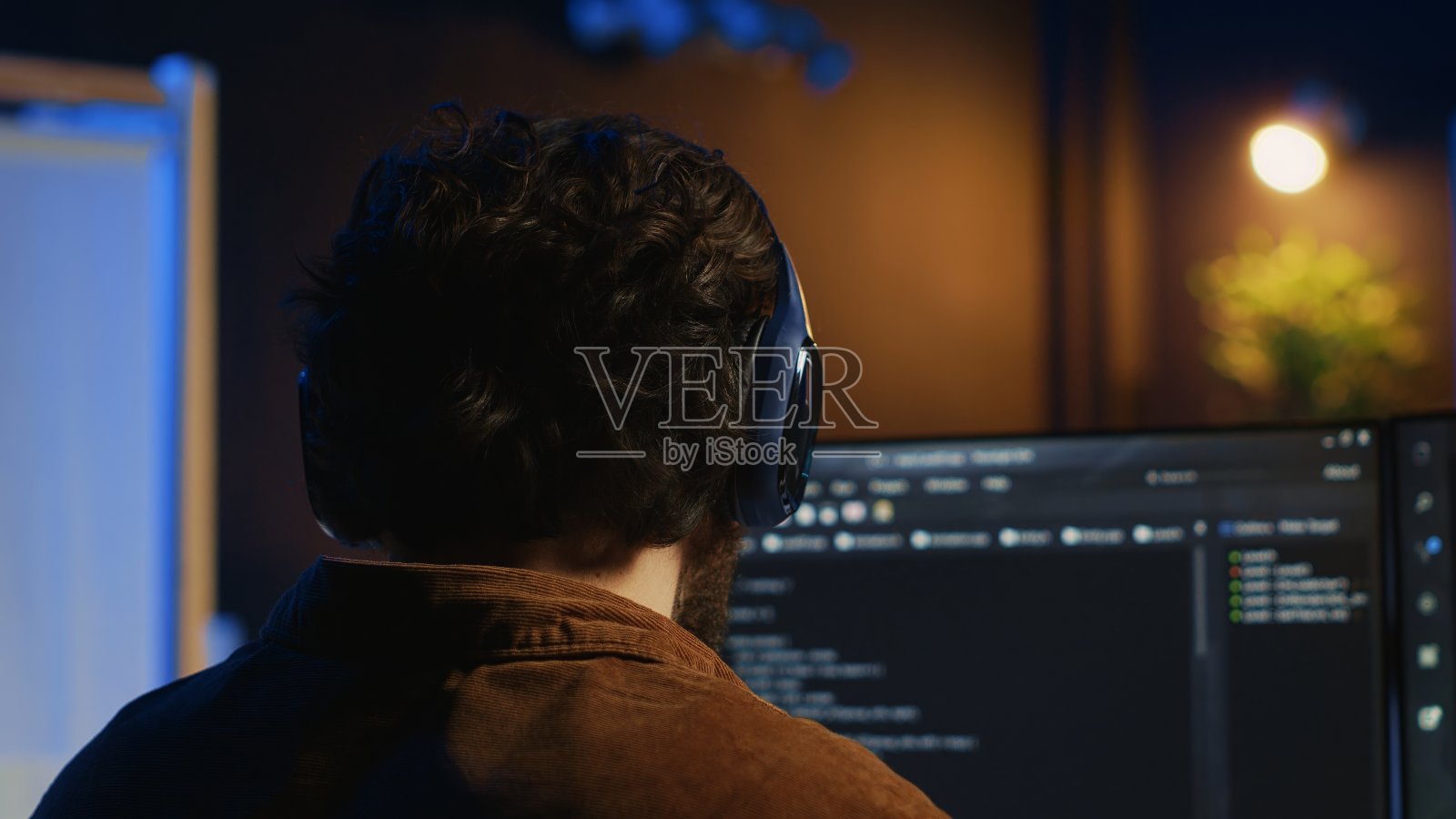 技术人员一边听音乐，一边用编码来加强防火墙照片摄影图片