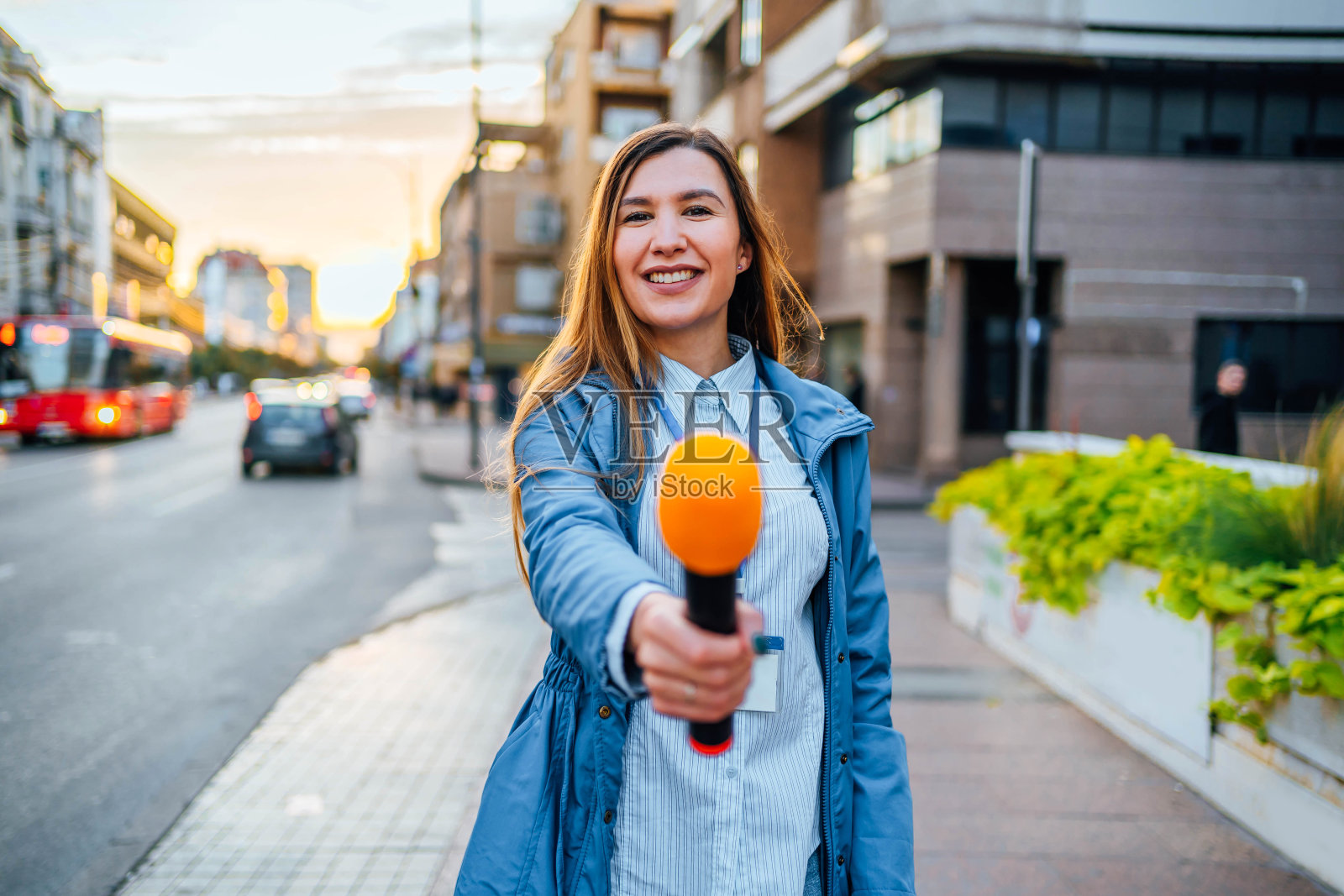 女记者拿着麦克风进行采访照片摄影图片