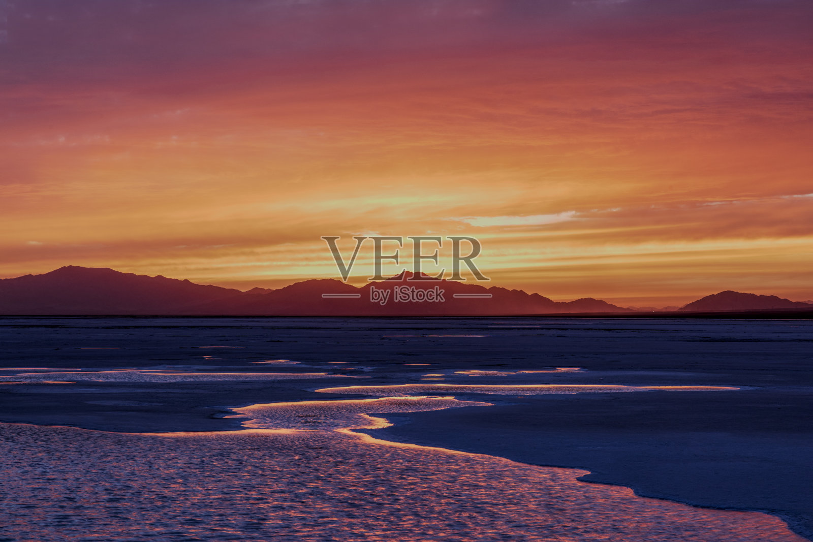 黄昏时湖面反射出的戏剧性的天空照片摄影图片