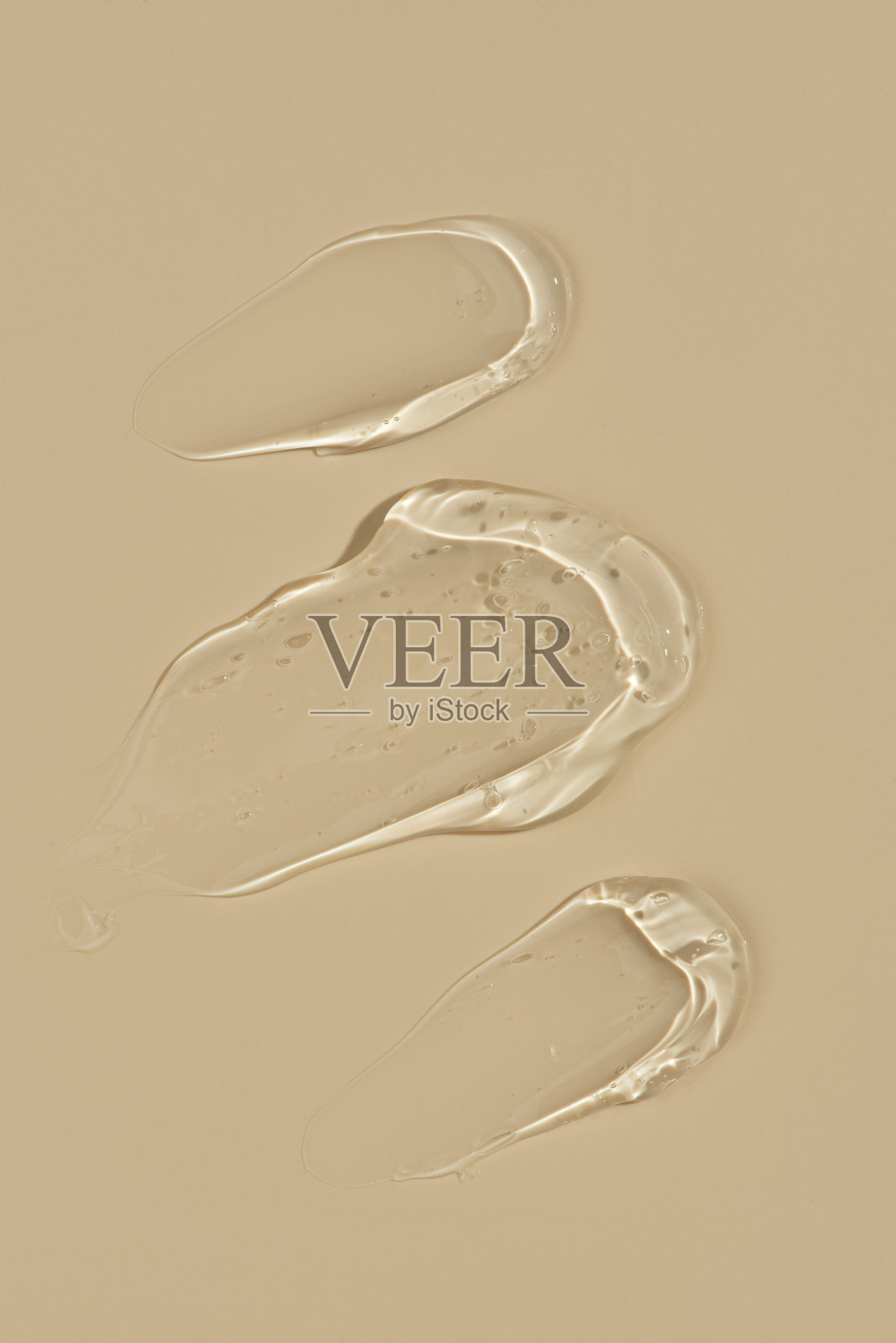 米色背景上的透明凝胶笔触，宏观纹理照片摄影图片