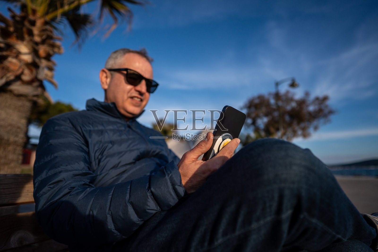 男子仍在户外水平通信时用智能手机与CAM通话照片摄影图片