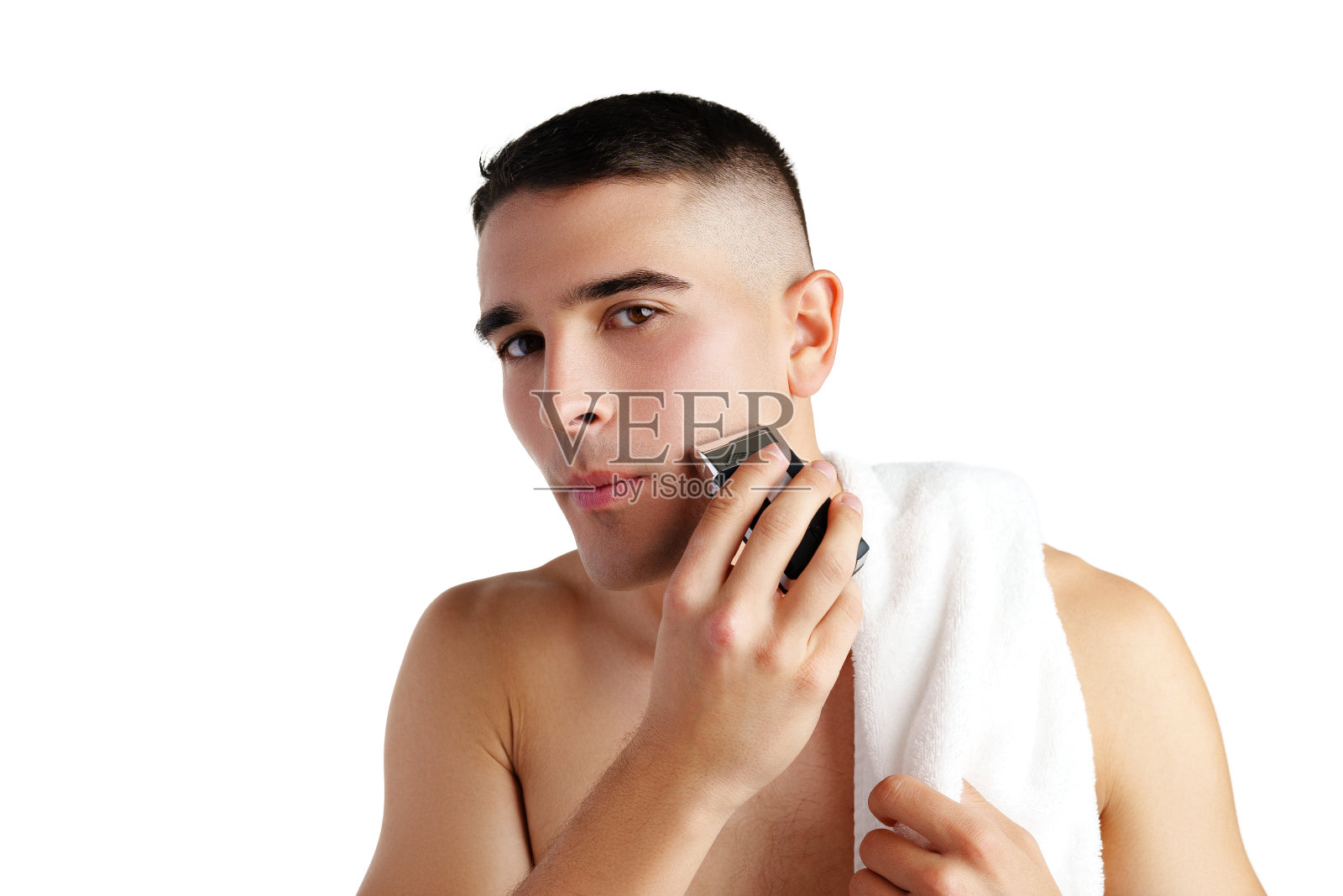 英俊的年轻人用白色背景的电动剃须刀刮脸照片摄影图片