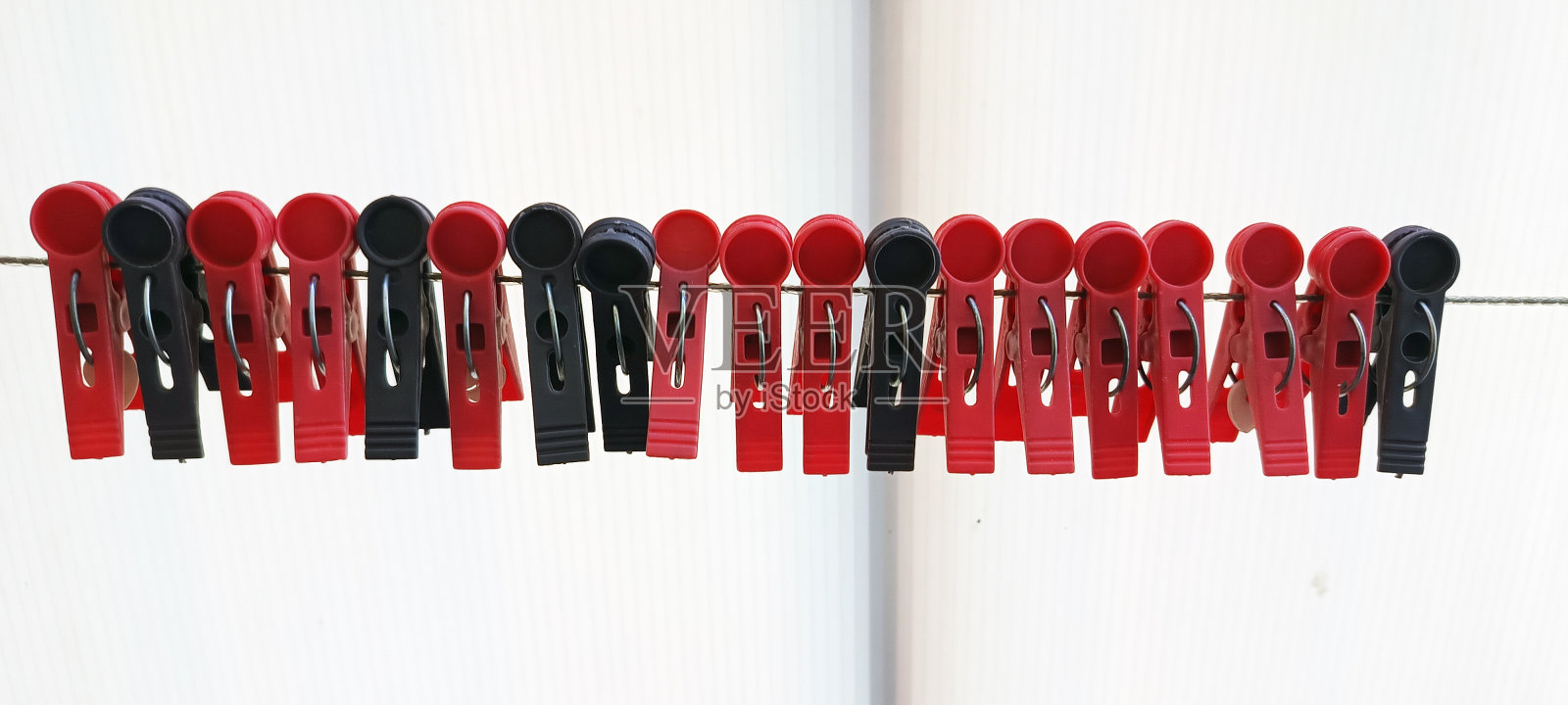 白色背景上的红黑衣夹照片摄影图片