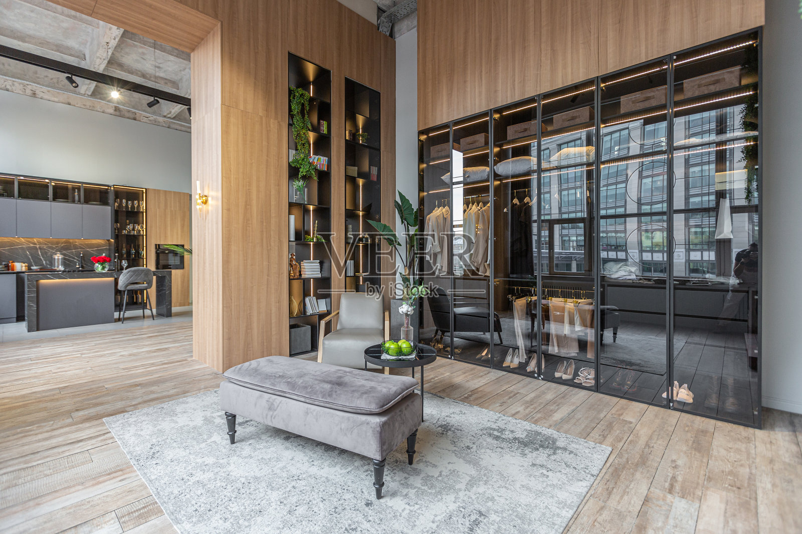 时尚的更衣室，led灯在巨大的现代宽敞的公寓，高阁楼风格的天花板，木制装饰和灰色墙壁照片摄影图片