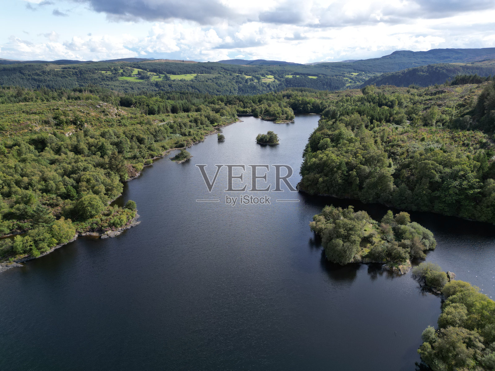 鸟瞰一个被茂密的绿叶环绕的湖泊照片摄影图片