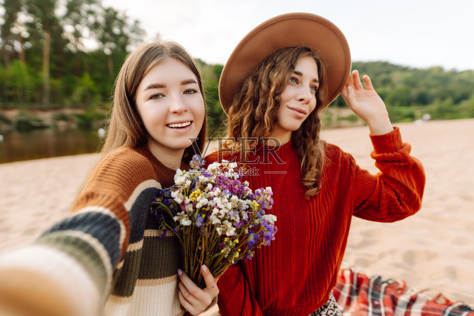 快乐的女人在沙滩上自拍。春天的天气。照片摄影图片
