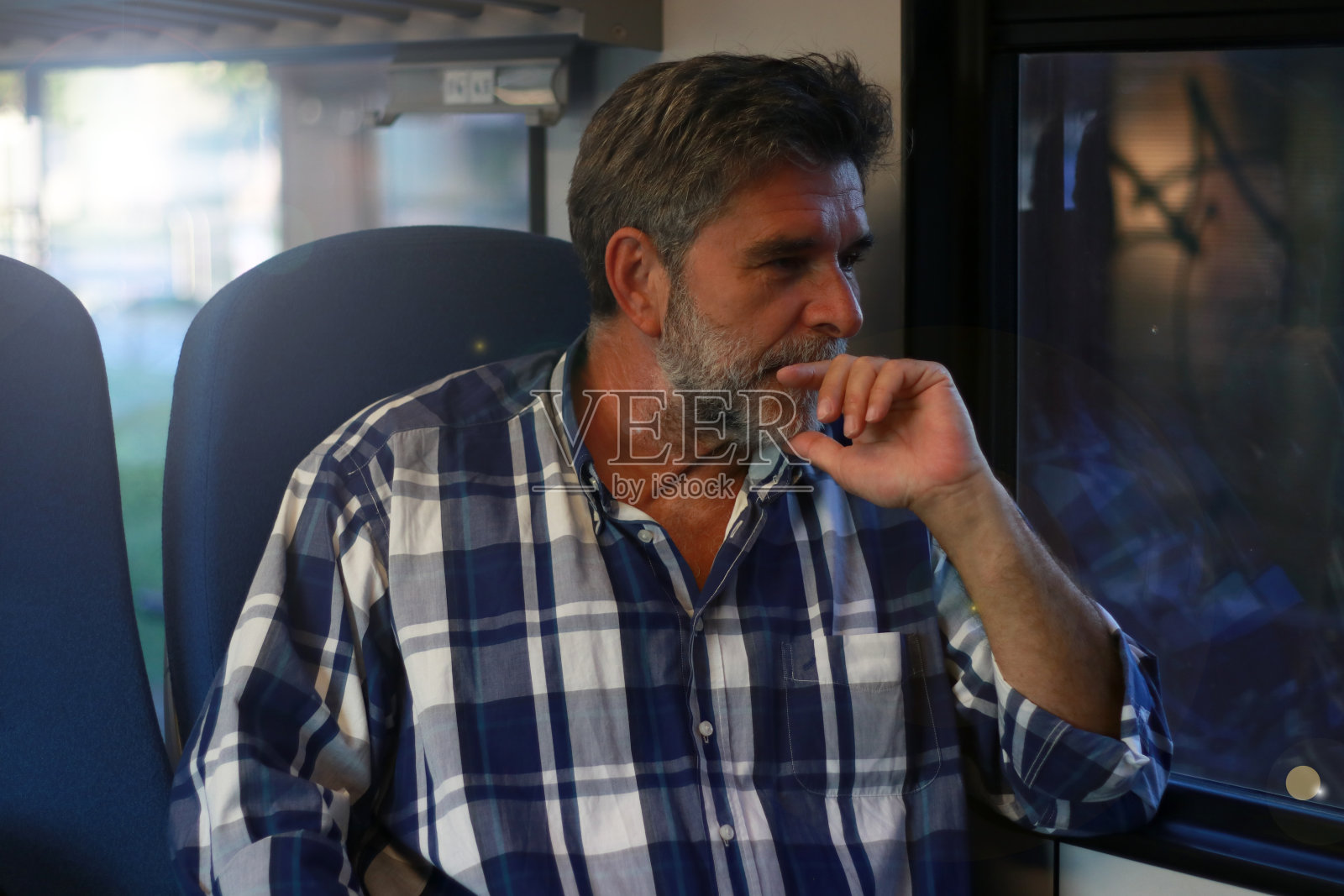 成熟的大胡子男人坐在火车上旅行照片摄影图片