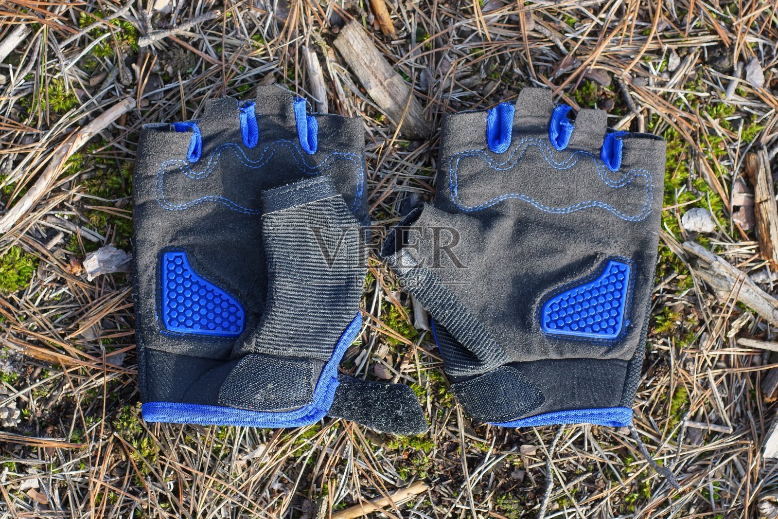 两只蓝黑色的自行车手套躺在地上照片摄影图片