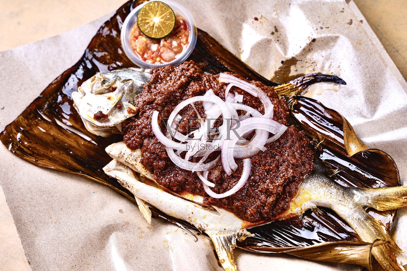 亚洲新鲜炒锅煎烧烤烤海鲜海鲈鱼加辣洋葱辣椒参巴酱酸橙香蕉叶咖啡馆酒店豪华清真素食餐厅宴会菜单照片摄影图片