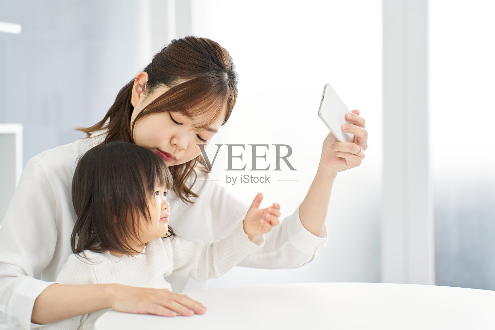 妈妈从孩子手里拿走智能手机照片摄影图片