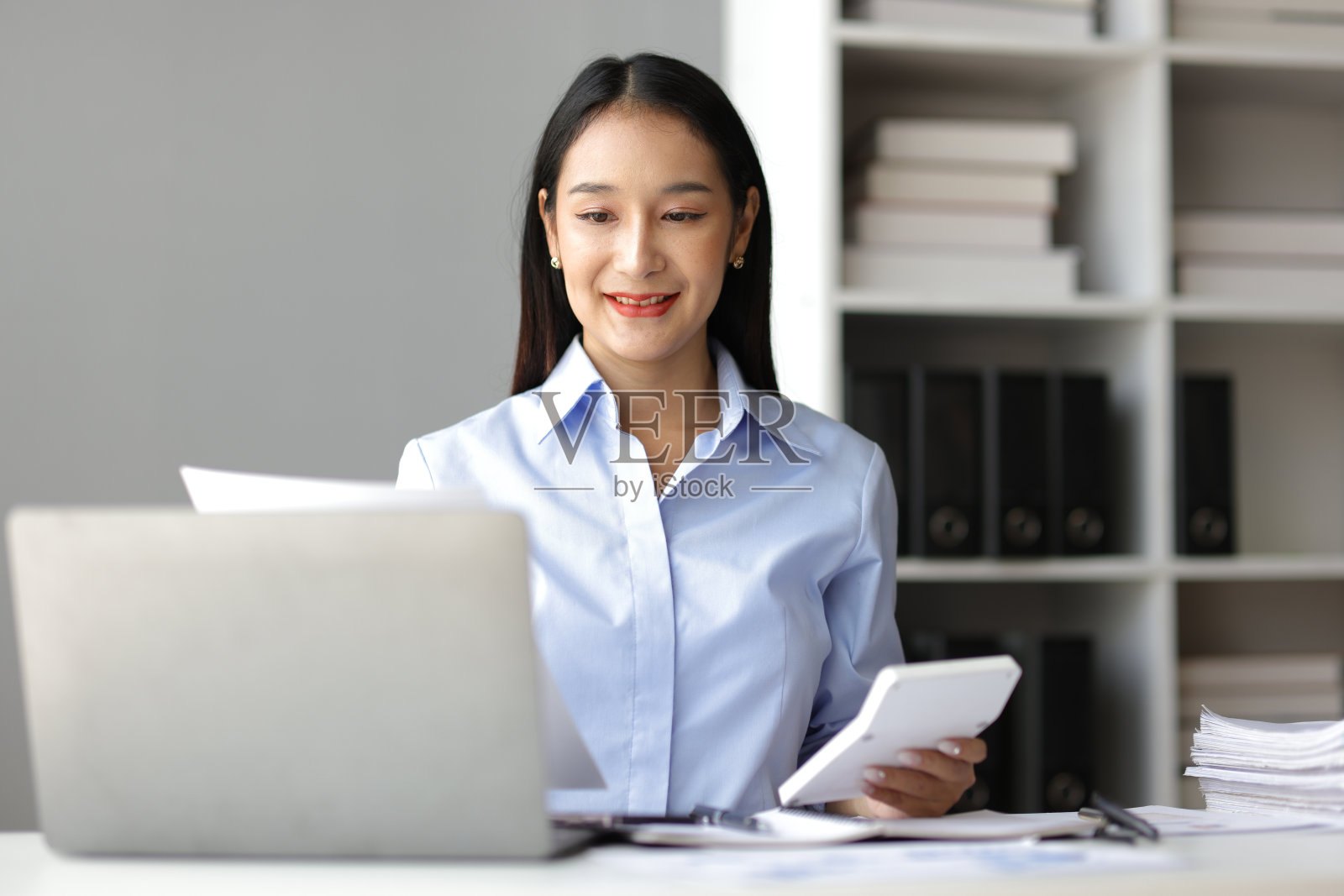 与文件打交道的女商人是统计分析财务数据，计算收入和支出，管理预算和规划财务。照片摄影图片