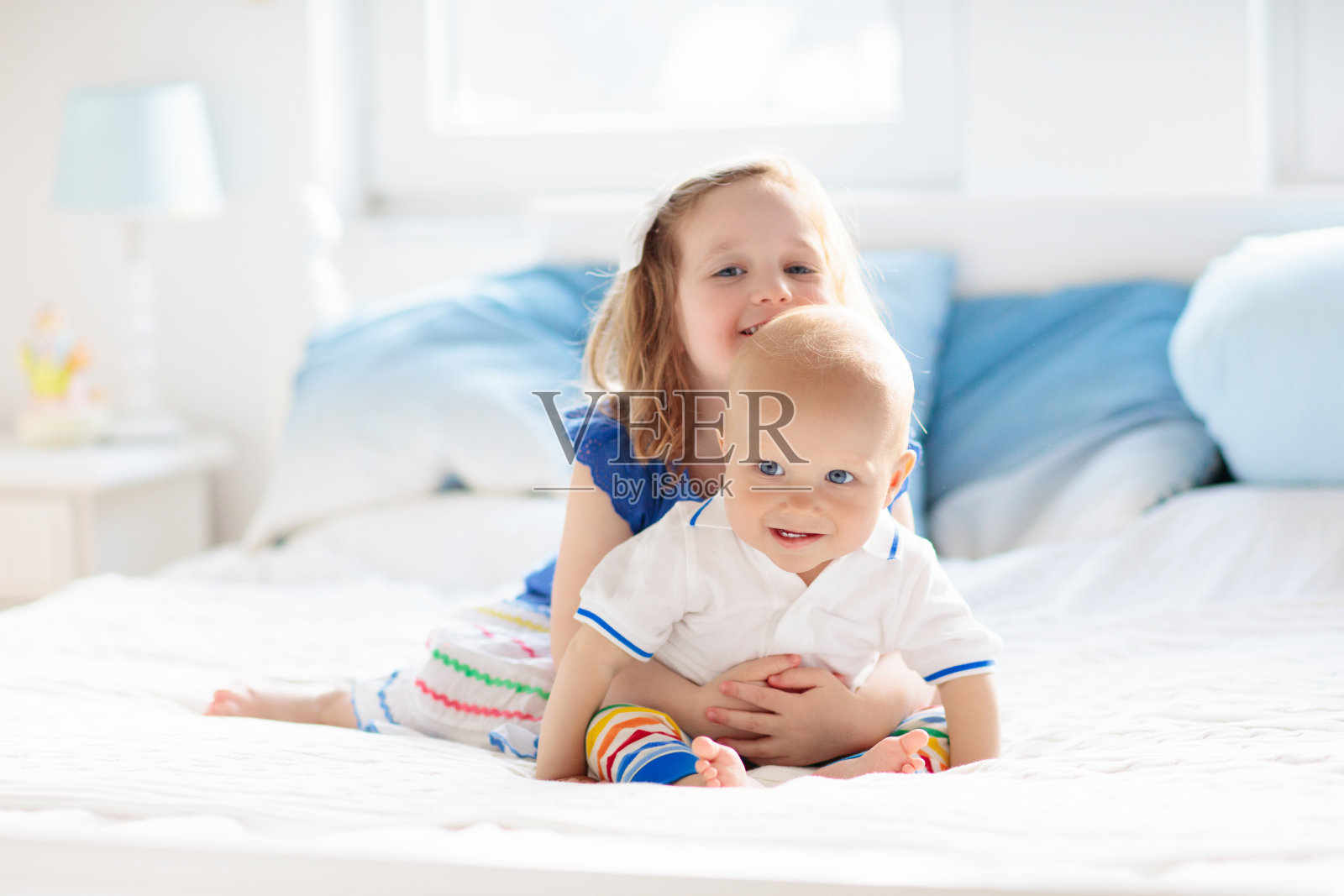 孩子们在父母的床上玩耍照片摄影图片