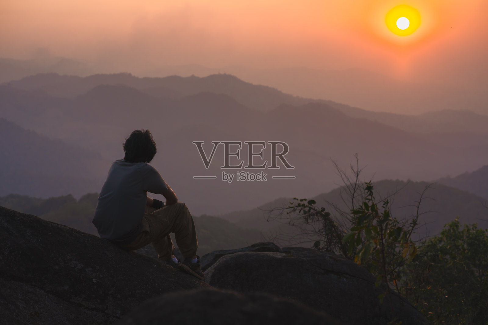 风景和旅行的概念与单独的自由职业者在山顶放松和日落与山的层照片摄影图片