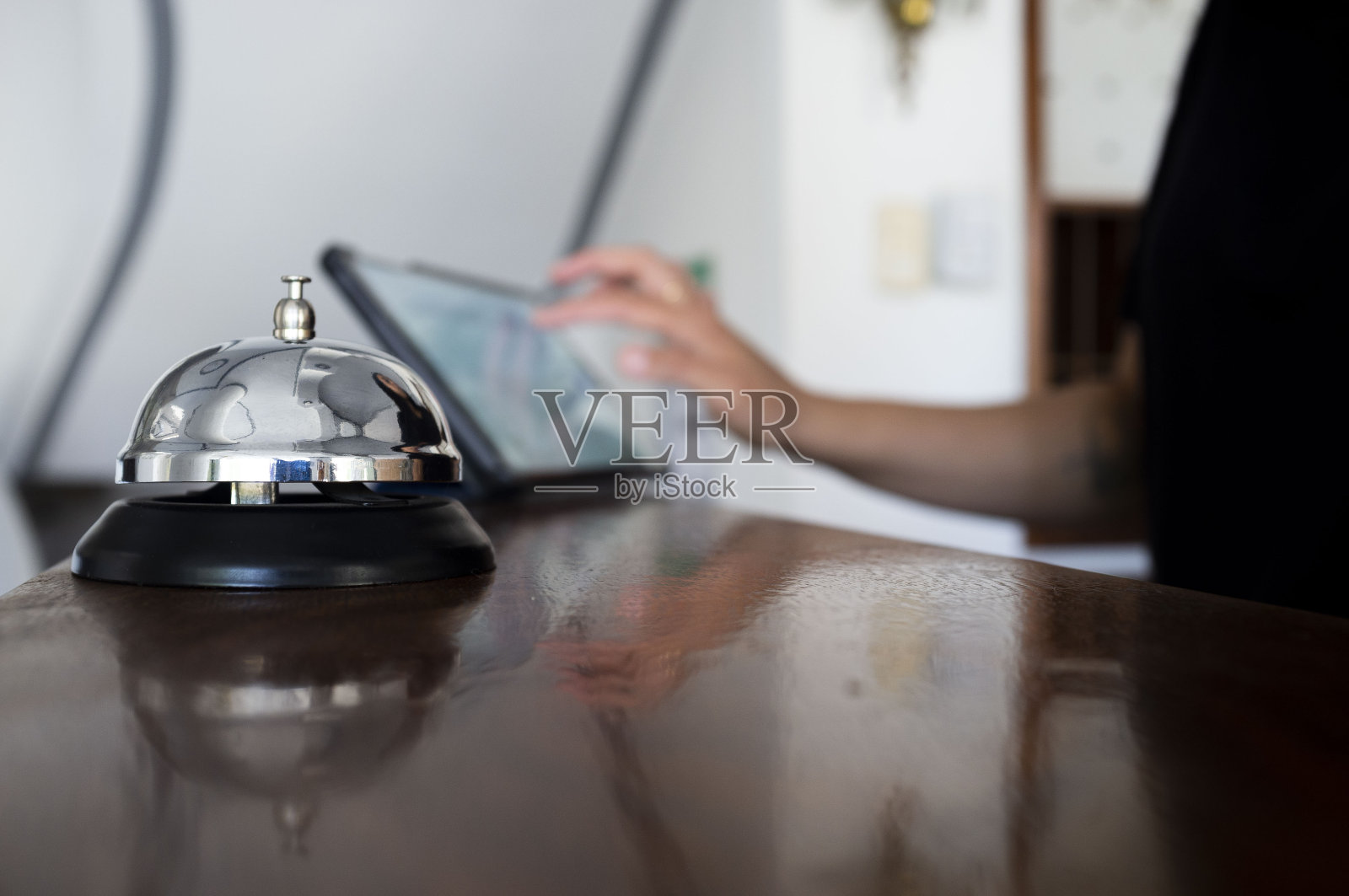 女酒店工作人员在前台与酒店服务员办理入住手续照片摄影图片