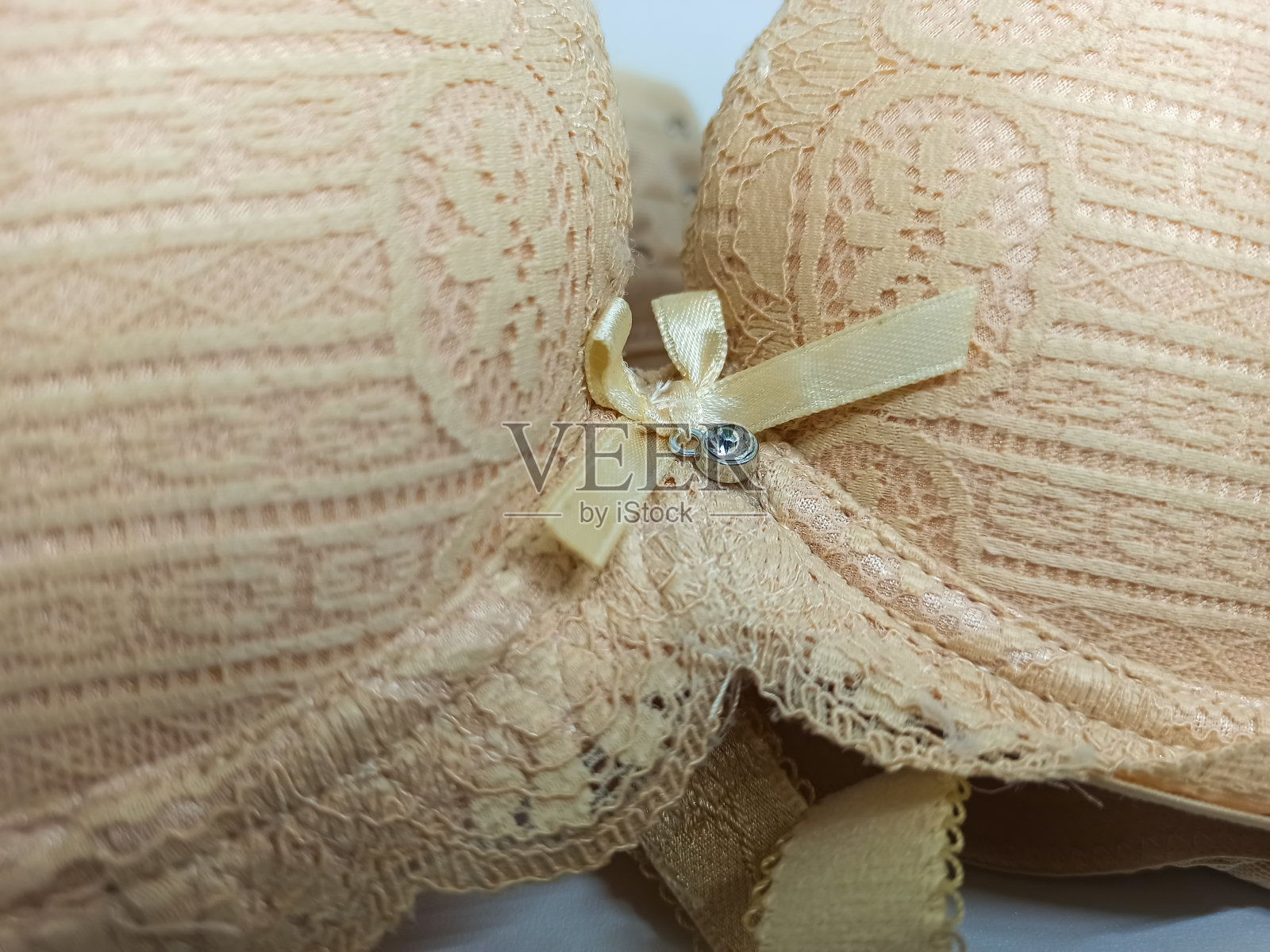 这款乳白色文胸的锦缎图案更加吸引人。照片摄影图片