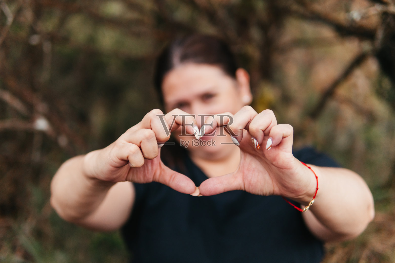 在哥伦比亚的帕拉莫，一名妇女用手做了一个心形照片摄影图片