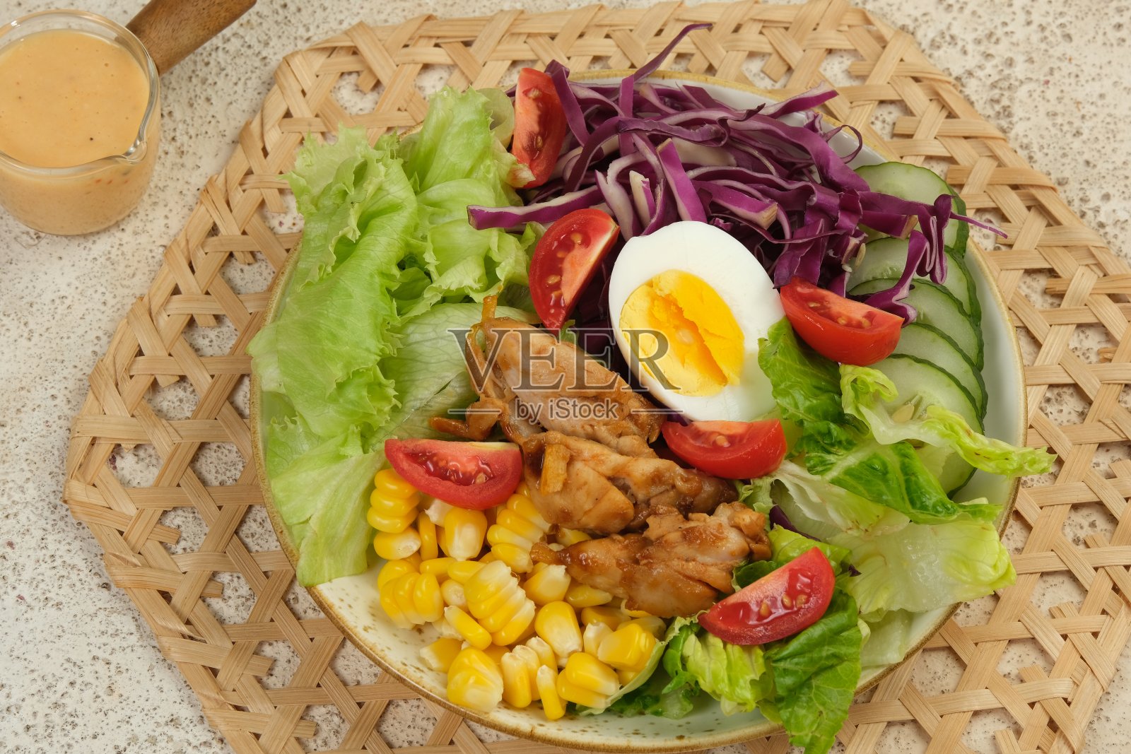 健康蔬菜沙拉，新鲜番茄，黄瓜，生菜，红卷心菜，玉米煮鸡蛋和烤鸡，装盘。饮食菜单。前视图。照片摄影图片