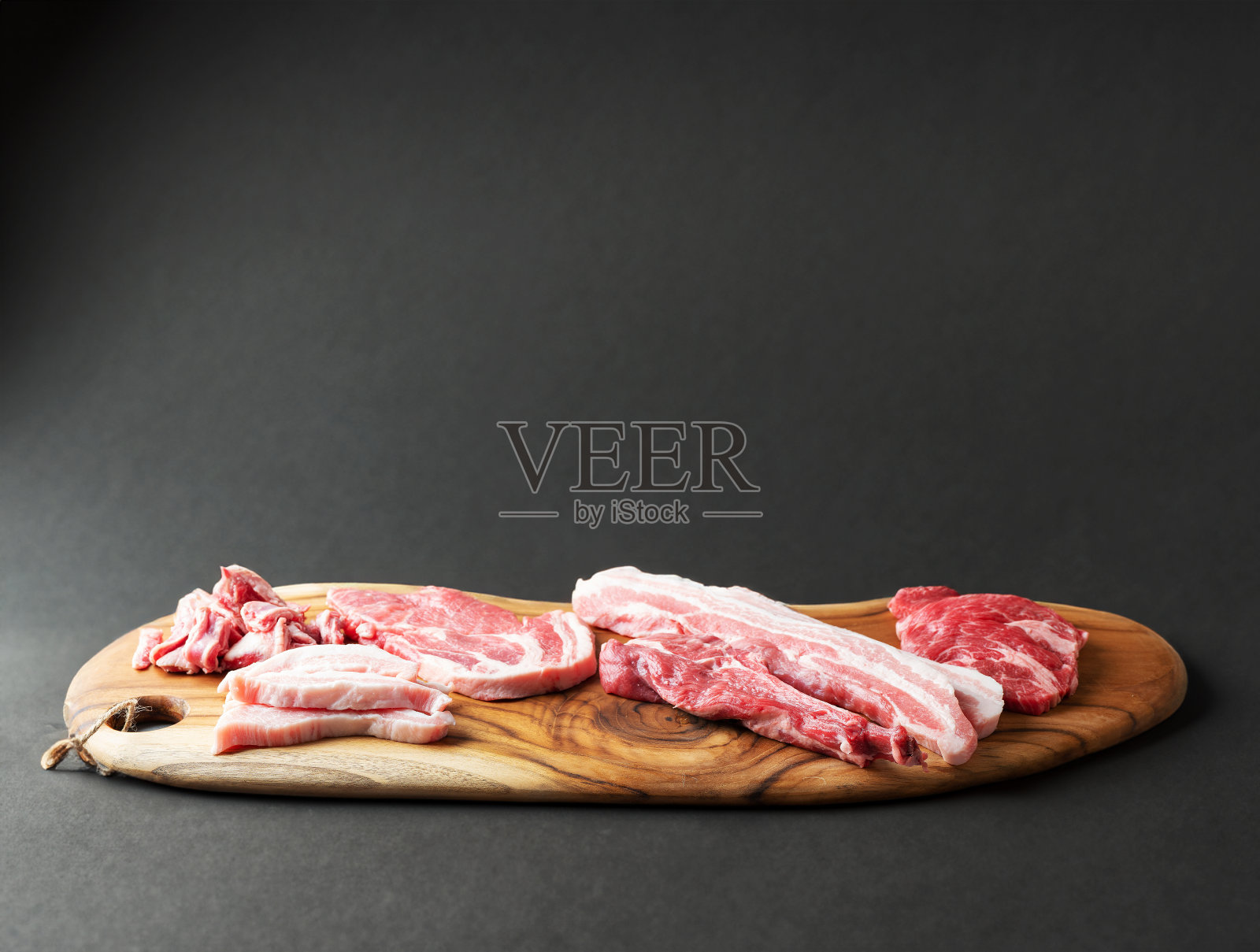 把肉分成几部分放在木盘上照片摄影图片
