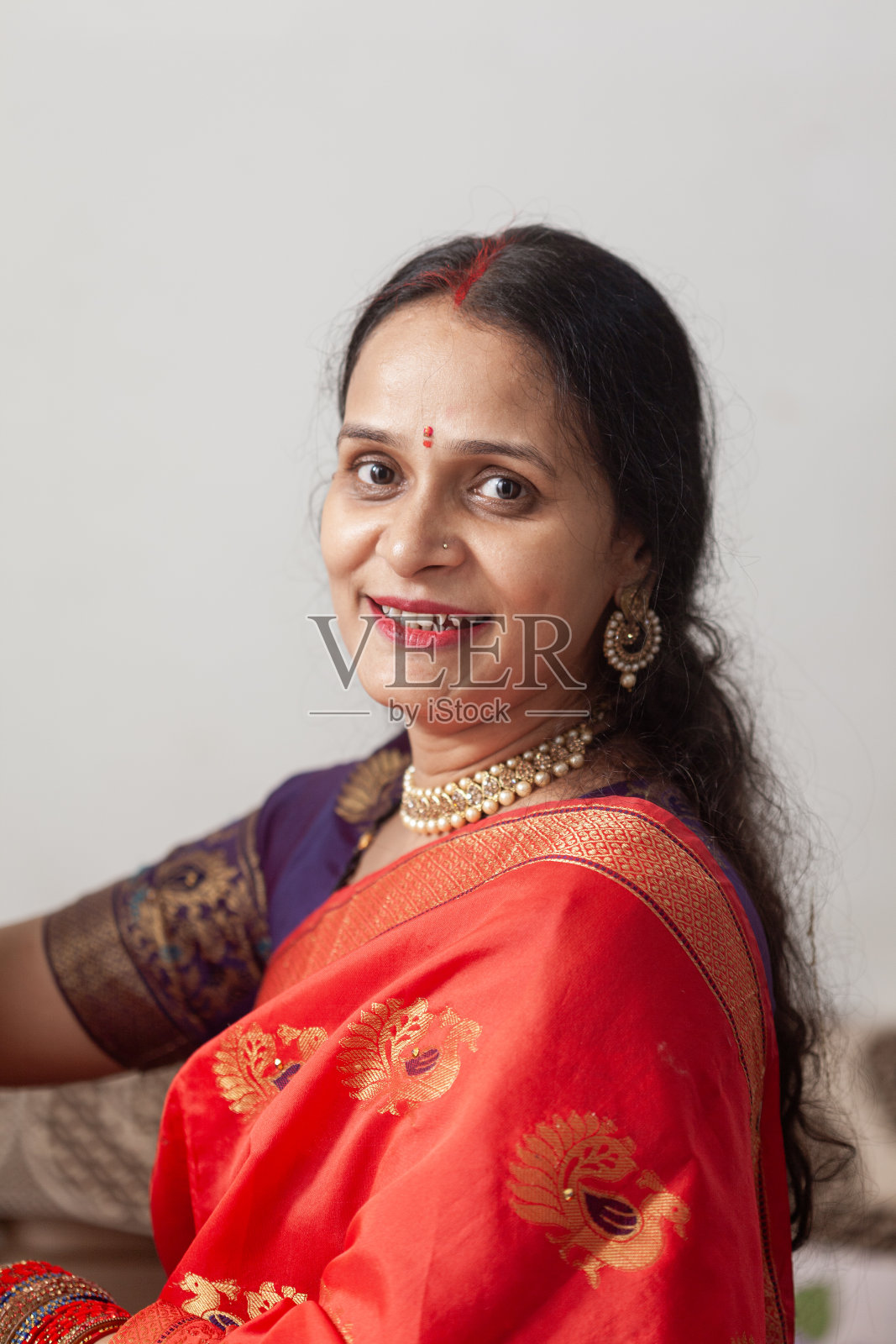 一个美丽快乐的印度女人直视着镜头。照片摄影图片