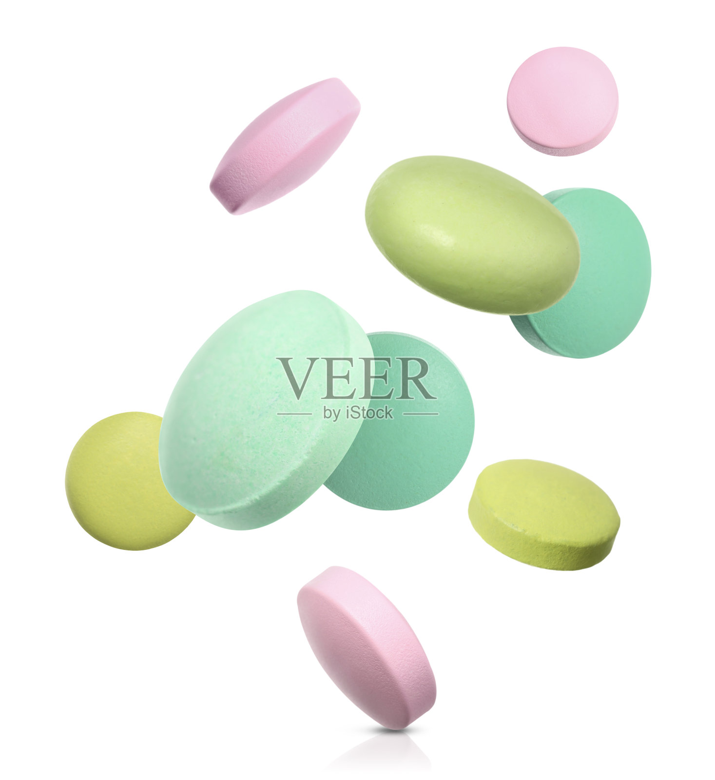 许多不同颜色的药丸落在白色的背景上照片摄影图片