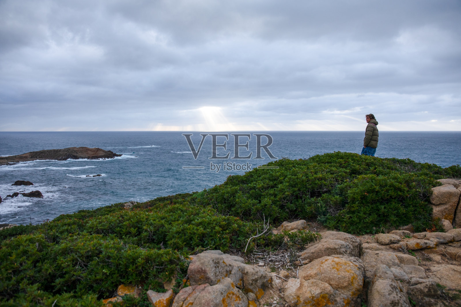 年轻人望着海浪，大海照片摄影图片