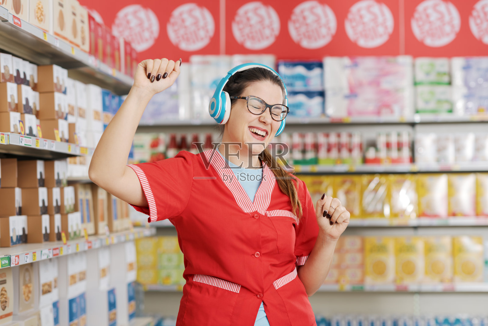 杂货店店员戴着耳机跳舞照片摄影图片