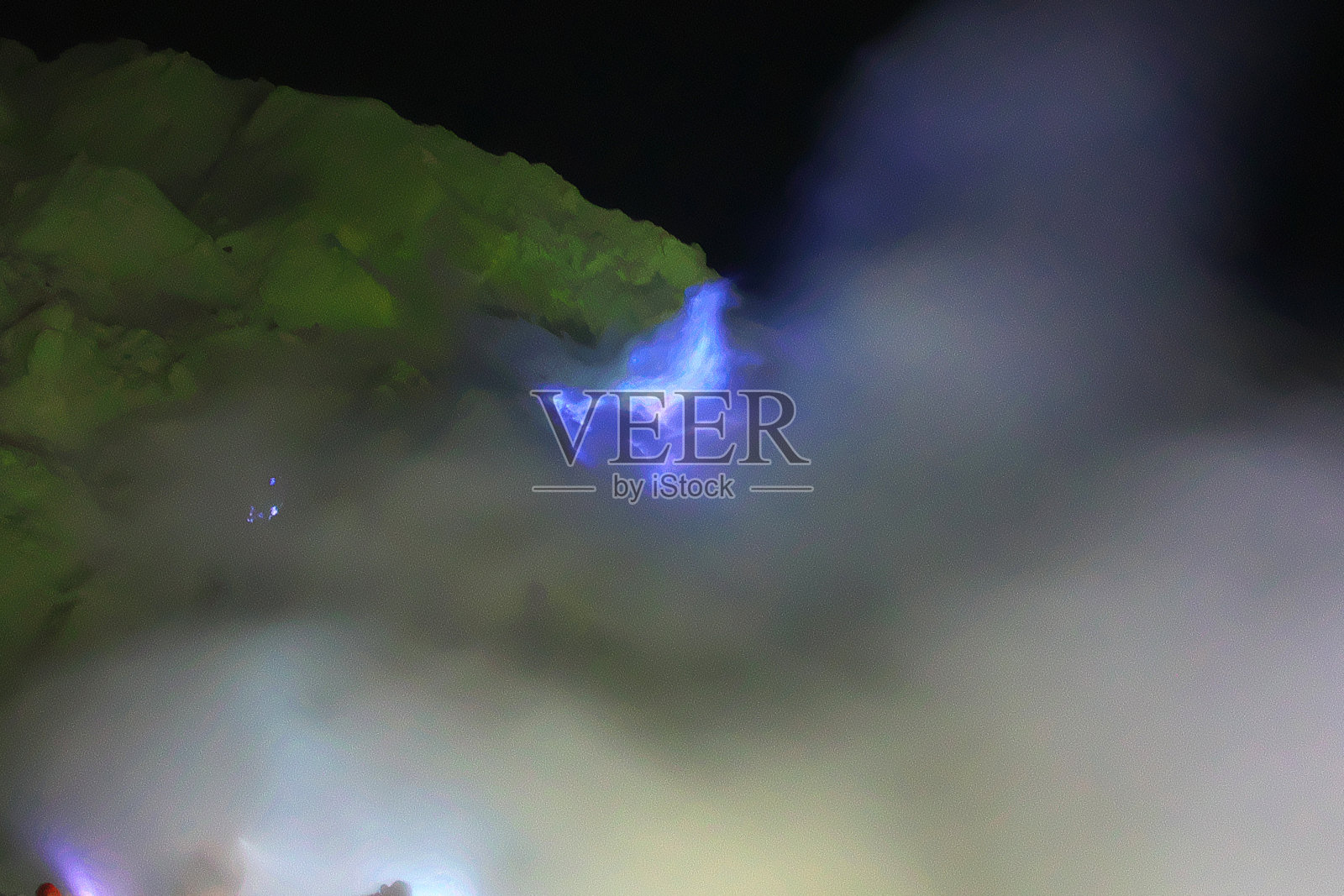 印度尼西亚伊真火山夜间雾中的蓝色火焰照片摄影图片