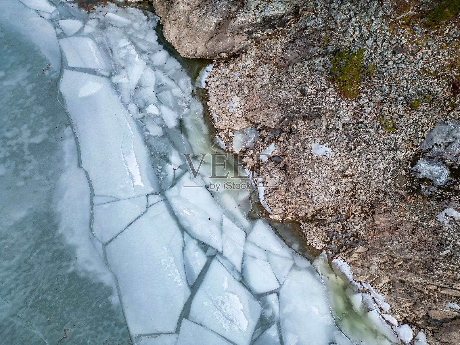岩石岸边湖泊的冰面航拍，加拿大不列颠哥伦比亚省照片摄影图片