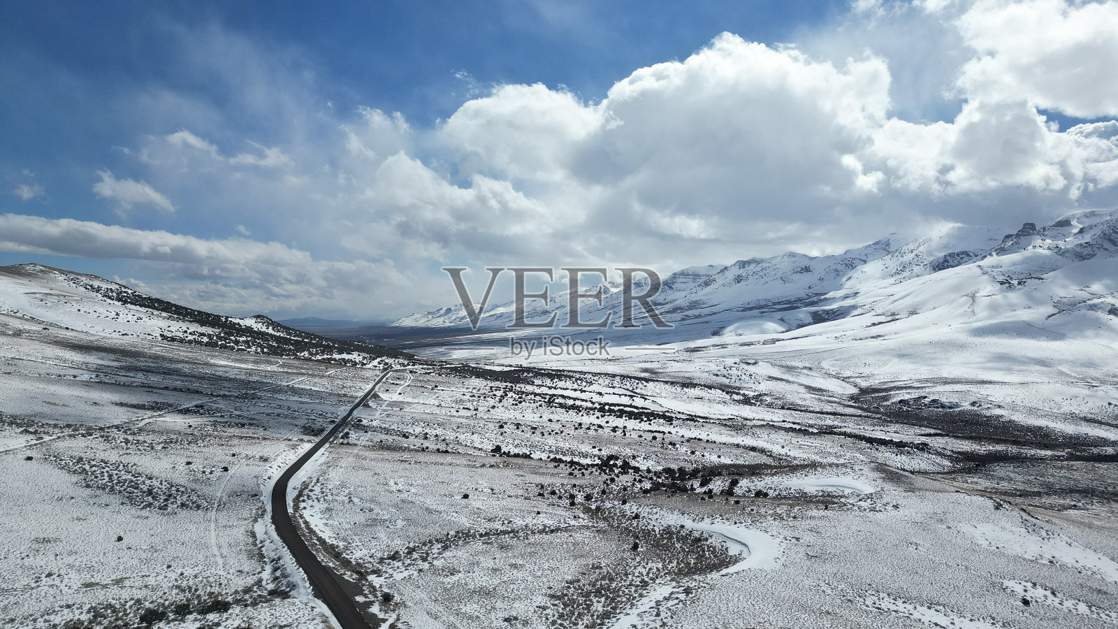 雪景显示道路蜿蜒进入山谷，没有车辆照片摄影图片