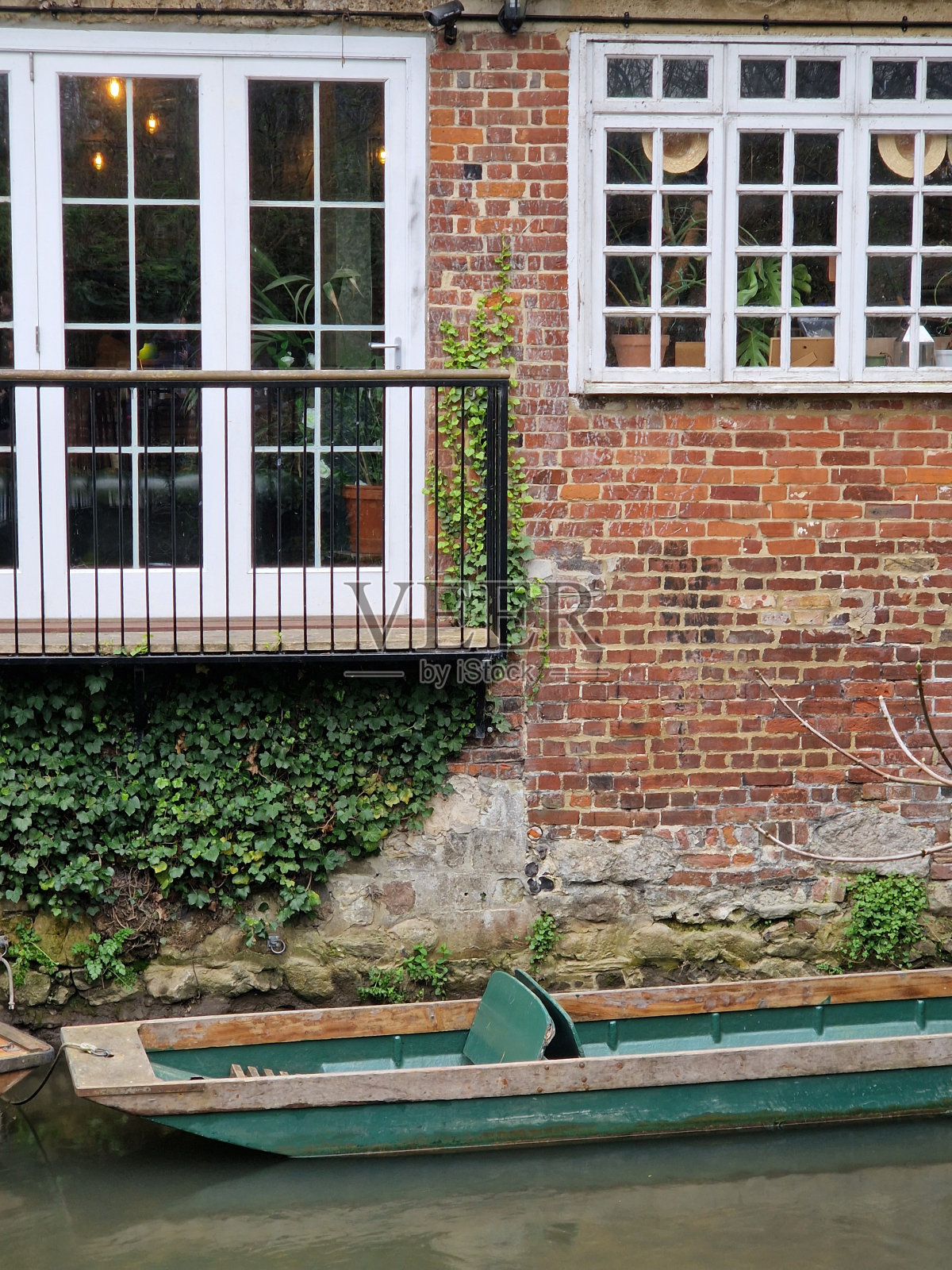 坎特伯雷市中心古老的石头门面前的小平底船(斯托河)照片摄影图片