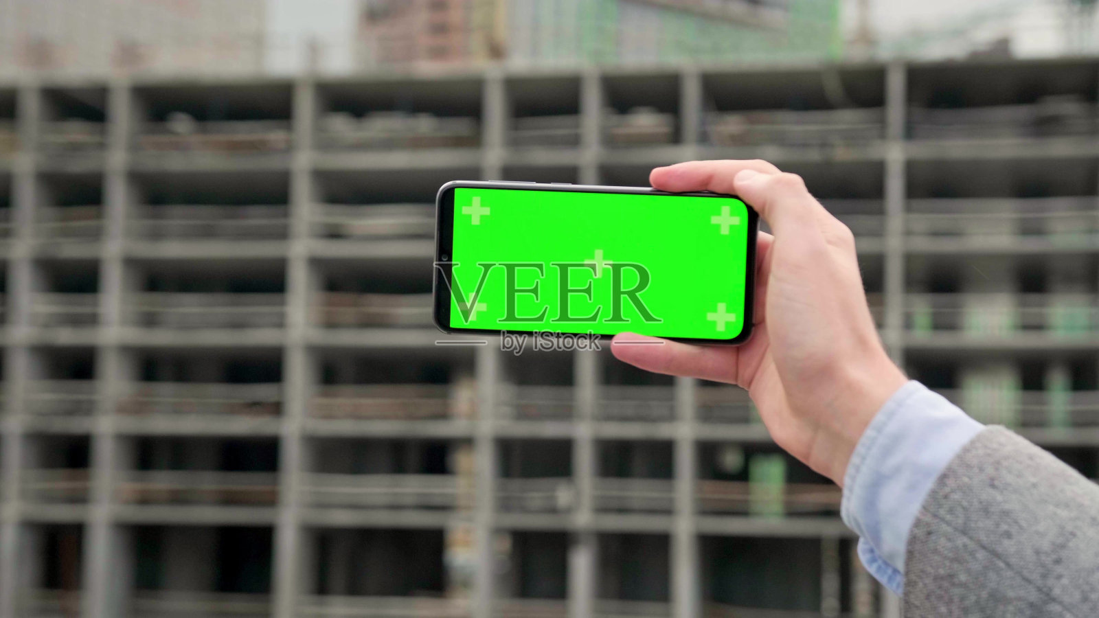 现场经理使用手机应用程序对施工对象进行监控照片摄影图片