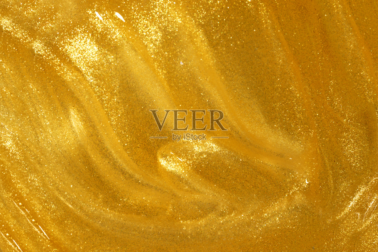 抽象的金色液体背景，油漆飞溅，漩涡图案，美容凝胶和化妆品纹理照片摄影图片